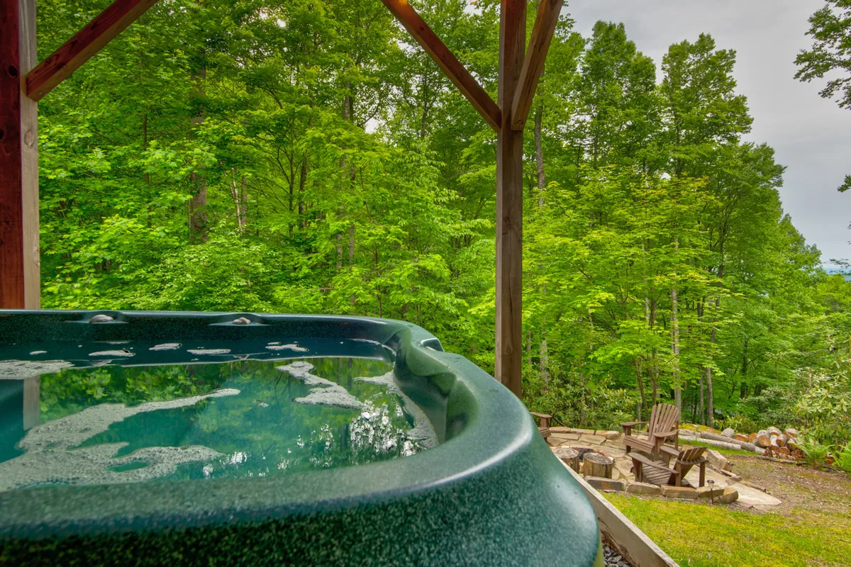 A lush backyard scene features a hot tub, fire pit, Adirondack chairs, and green lawn. This inviting setting is ideal for outdoor relaxation, gatherings, and playful moments on the lawn, as highlighted in the section's description.